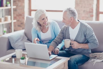 Two elderly people are sitting at home